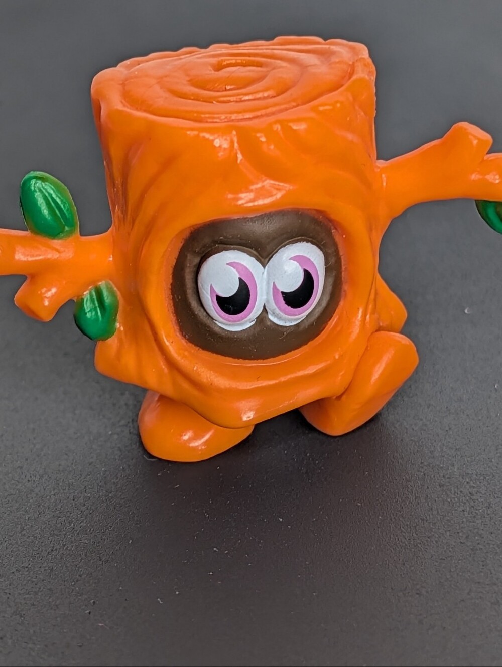 Orange tree stump toy with green leaves